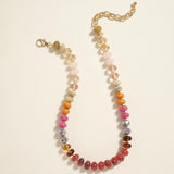 Bead necklace in rust oranges, pinks and clear colors