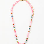 Pink bead necklace with accenting red, blue, white and navy beads.
