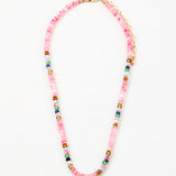 Pink bead necklace with accenting red, blue, white and navy beads.