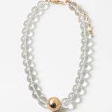 Necklace with clear beads and a gold ball pendant on a white background