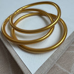 Picture of a set of three gold tube bangles