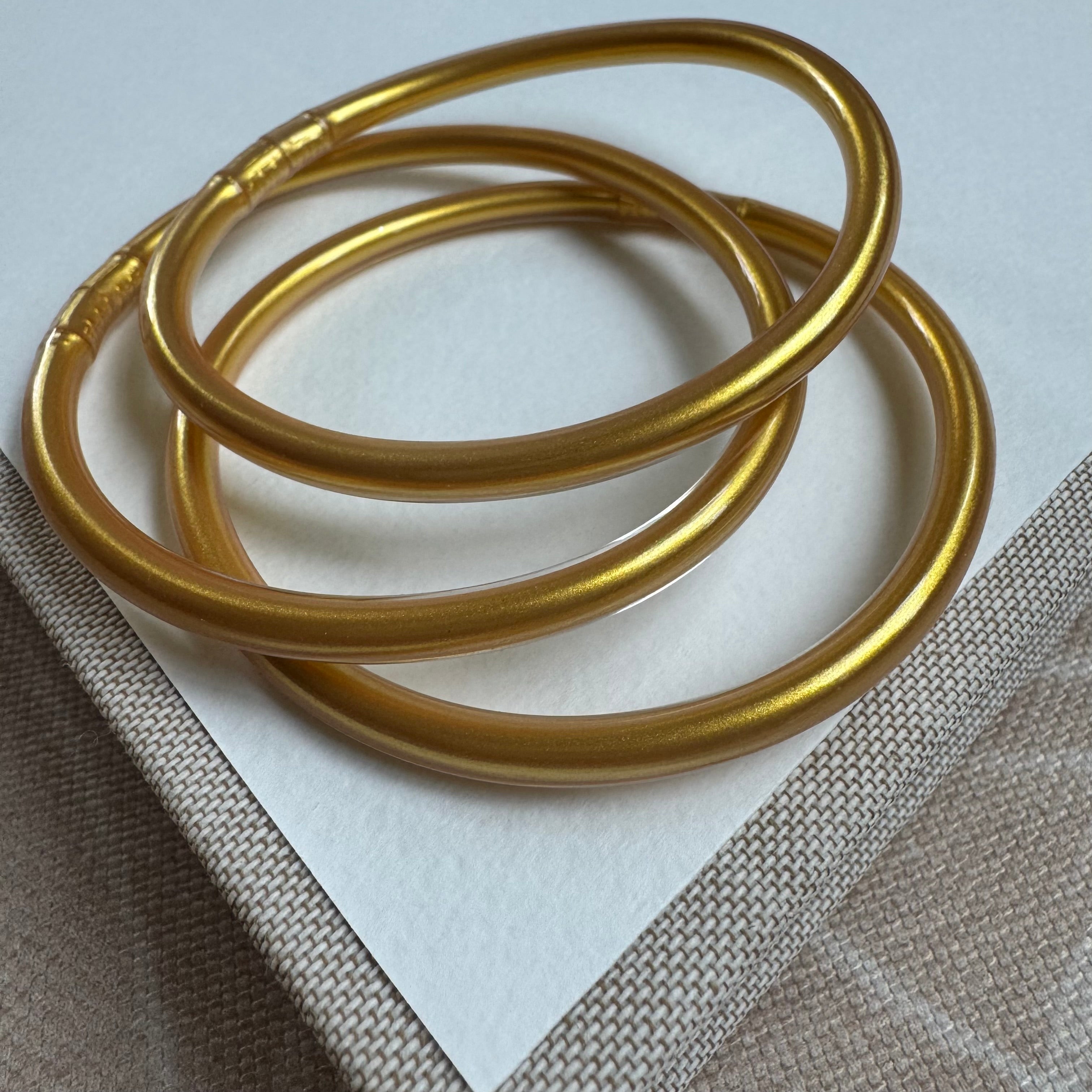 Picture of a set of three gold tube bangles
