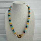 Picture of a necklace made of green, blue, white, yellow and pink beads with a large gold carabiner clasp.