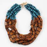 Necklace with blue beads and wooden blocks on a white background