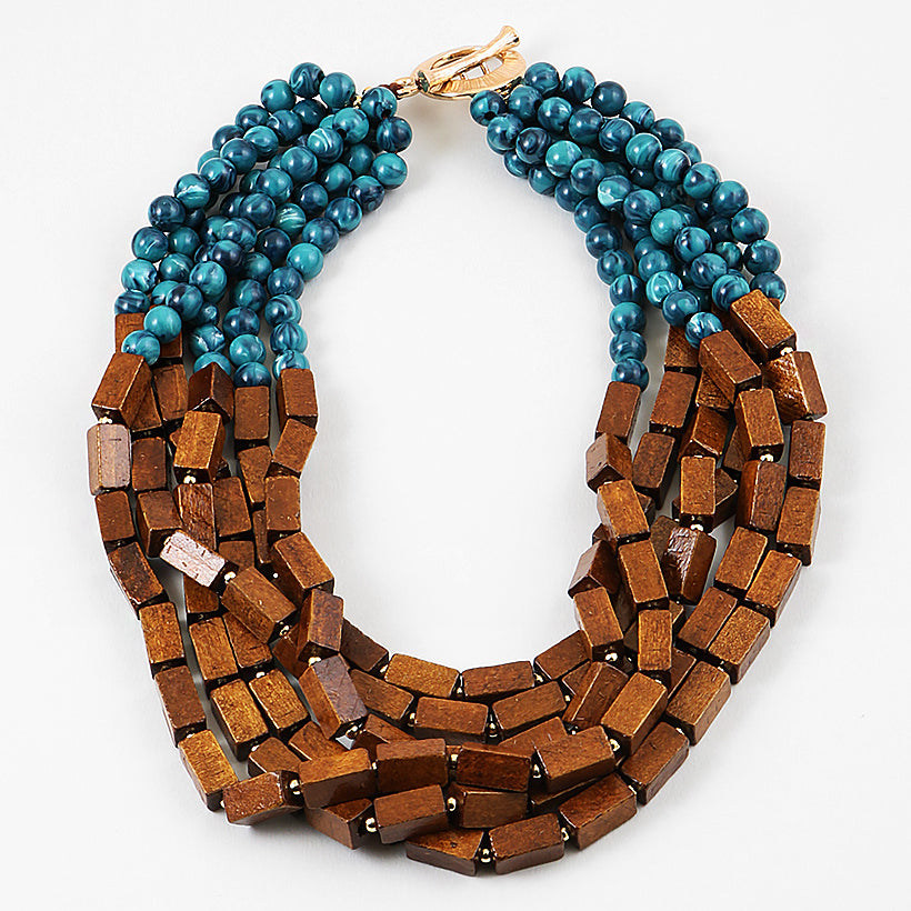 Necklace with blue beads and wooden blocks on a white background