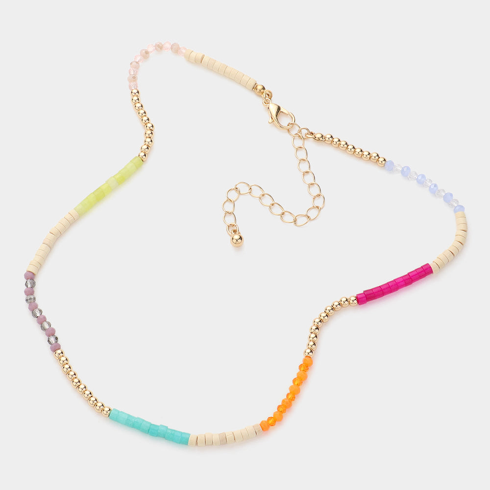 Necklace with colorful beads in pink, orange, teal, beige, gold and yellow beads on a white background
