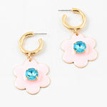 Small gold hoop earrings with large pink flowers dangling down with a light blue stone center.