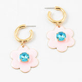 Small gold hoop earrings with large pink flowers dangling down with a light blue stone center.