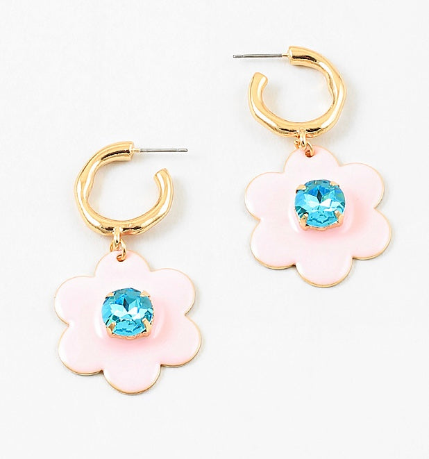 Small gold hoop earrings with large pink flowers dangling down with a light blue stone center.