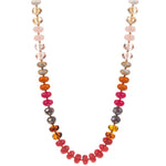Necklace with multicolored beads in pinks and oranges  on a white background