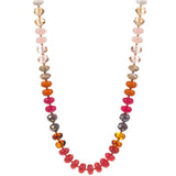 Necklace with multicolored beads in pinks and oranges  on a white background
