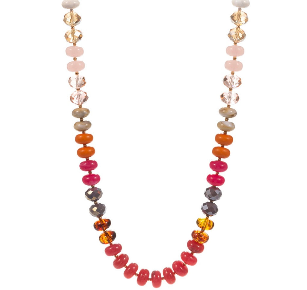 Necklace with multicolored beads in pinks and oranges  on a white background