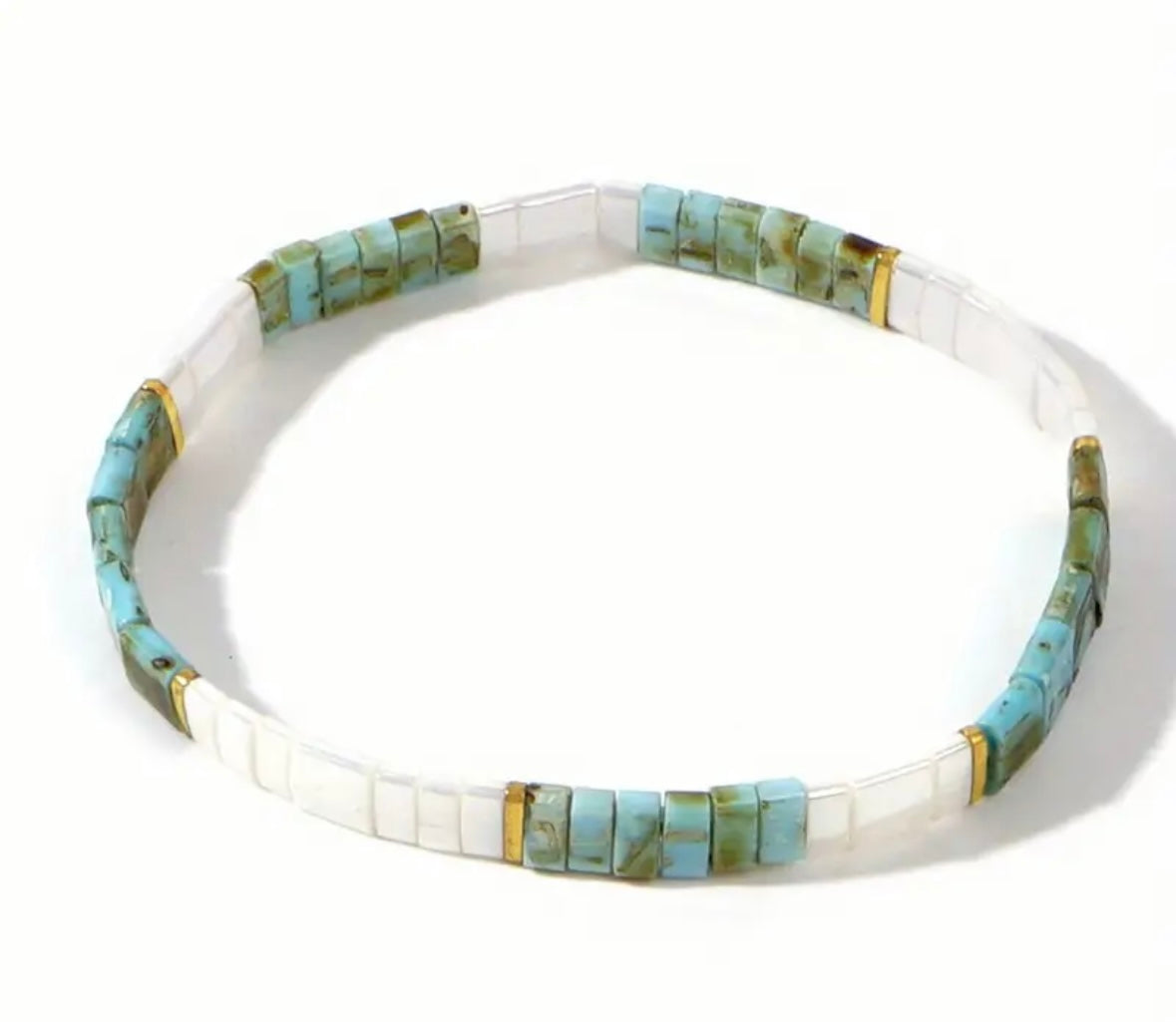 Necklace with turquoise and white rectangle beads on a white background
