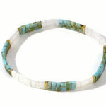 Necklace with turquoise and white rectangle beads on a white background