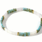Necklace with turquoise and white rectangle beads on a white background