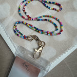 Picture of a multicolored beaded lanyard attached to a tag holder.
