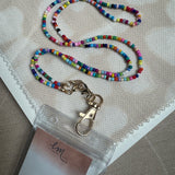 Picture of a multicolored beaded lanyard attached to a tag holder.