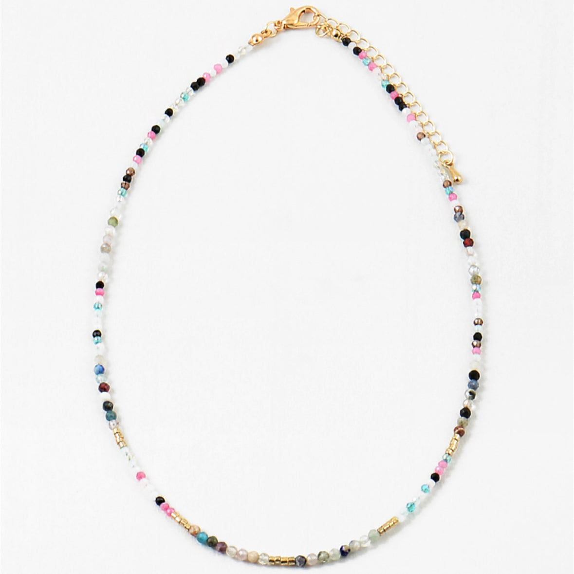 Multicolored beaded necklace in contrasting dark and white colors on a white background