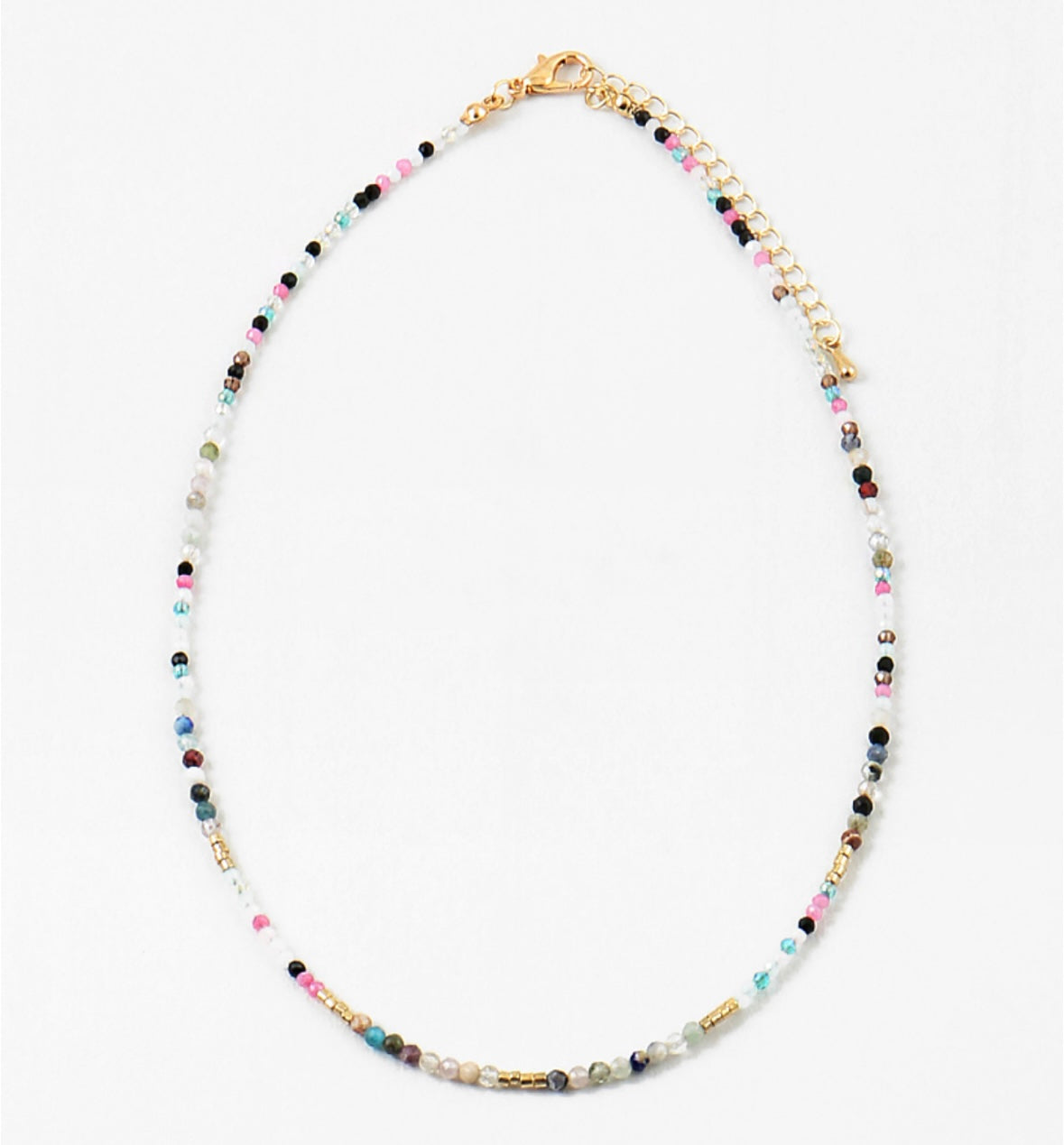 Multicolored beaded necklace in contrasting dark and white colors on a white background