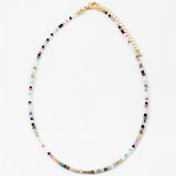Multicolored beaded necklace in contrasting dark and white colors on a white background