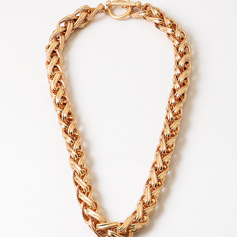 Gold chain necklace on a white background