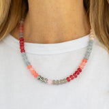 Red, gray, coral and green tinted beaded necklace.