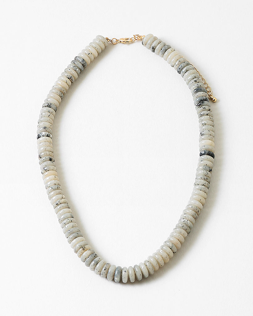 Necklace with white and black stone beads on a white background