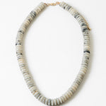 Necklace with white and black stone beads on a white background