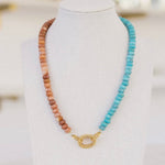 Clay and turquoise colored beaded necklace with a gold clasp.