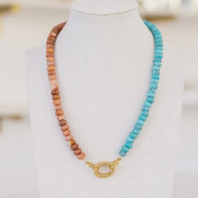 Clay and turquoise colored beaded necklace with a gold clasp.