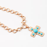 Large circle link gold chain with a toggle clasp. Necklace has a gold Cross with turquoise beads set in it as a pendant.