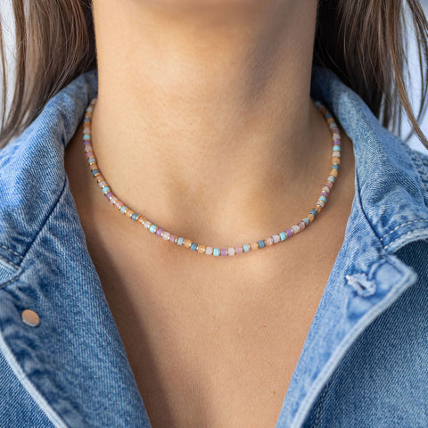 Delicate purple, peach and teal themed beaded necklace on model