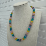 Picture of a necklace made of purple, blue, white, yellow and pink beads.