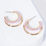 Set of double Gold hoops, one of the hoops is lined with light purple beads.