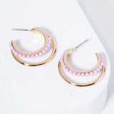 Set of double Gold hoops, one of the hoops is lined with light purple beads.