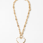 Picture of gold toggle chain with a large white heart pendant with a gold border.