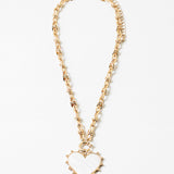 Picture of gold toggle chain with a large white heart pendant with a gold border.