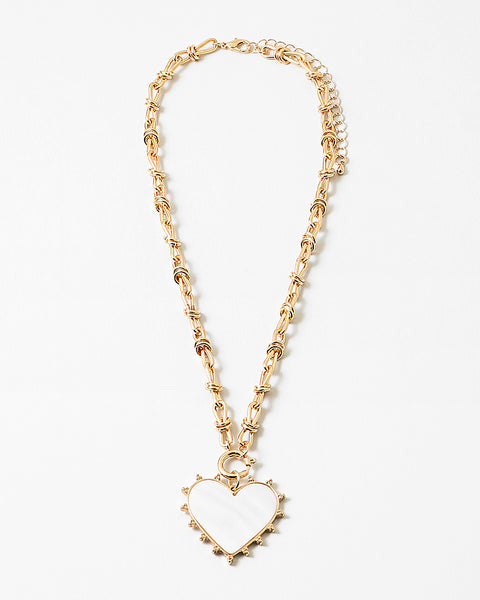 Picture of gold toggle chain with a large white heart pendant with a gold border.