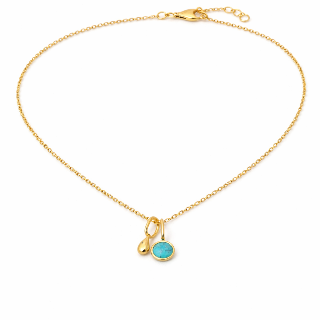 Gold necklace with a turquoise pendant on a white background