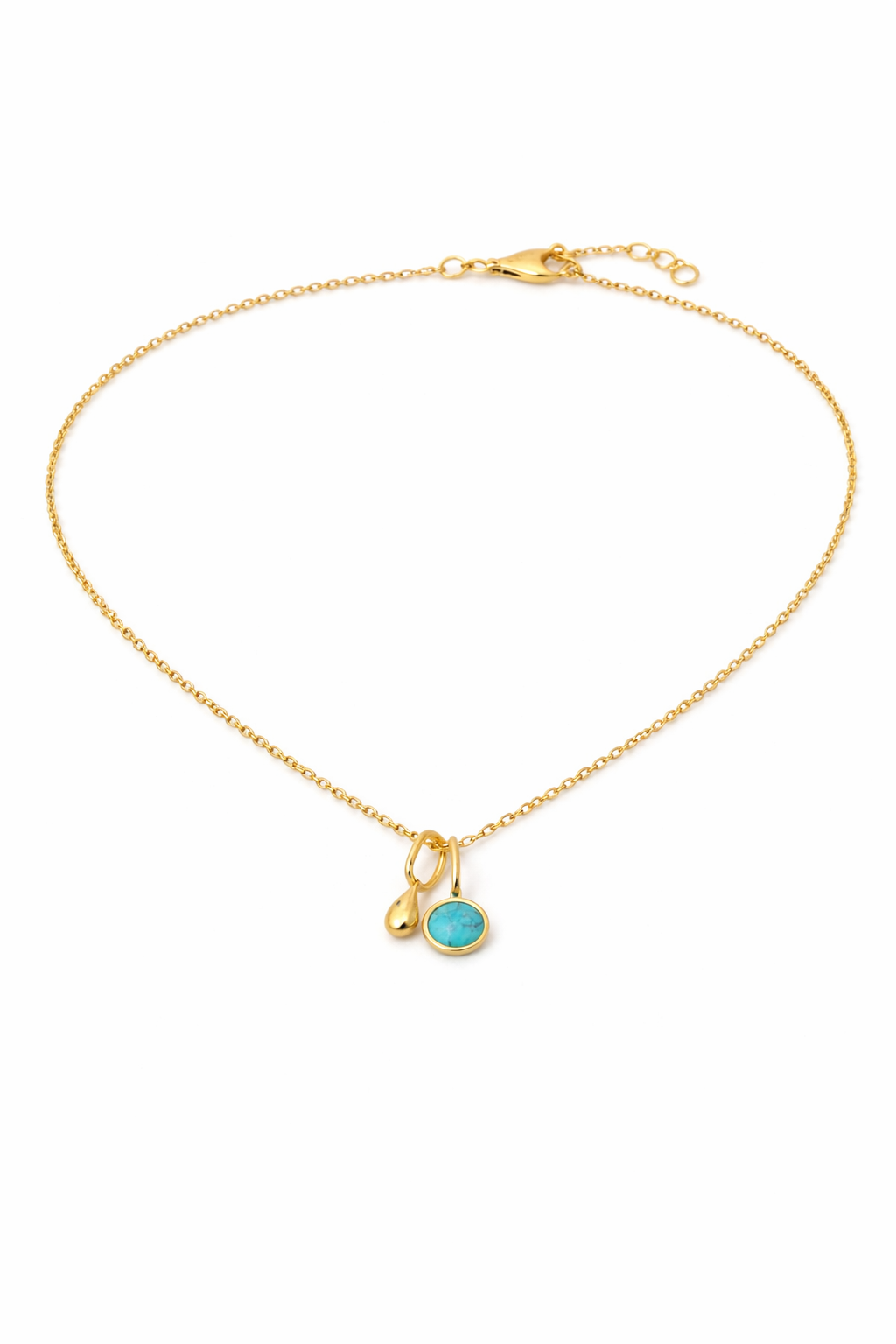 Gold necklace with a turquoise pendant on a white background