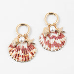 Set of half shell earrings with gold tipped edges. Earrings hang from small gold hoops with three small pendants dangling from them. One is a small golden conch, a golden starfish and a small fresh water pearl.