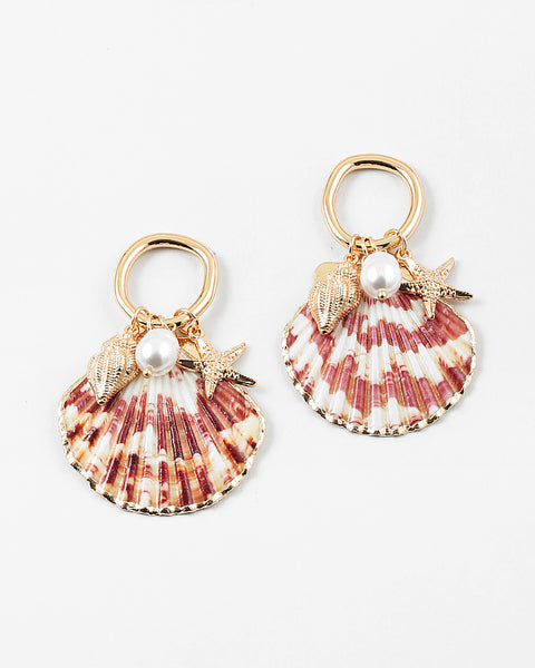 Set of half shell earrings with gold tipped edges. Earrings hang from small gold hoops with three small pendants dangling from them. One is a small golden conch, a golden starfish and a small fresh water pearl.
