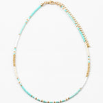 Picture of a dainty bead necklace made of turquoise, white and gold spacer beads.