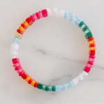 Picture of a single beaded bracelet in reds, oranges, pinks, whites and blues.
