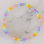 Picture of a brightly colored bracelet with light blue, light pink and yellow beads.