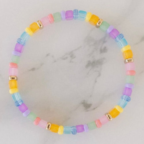 Picture of a brightly colored bracelet with light blue, light pink and yellow beads.