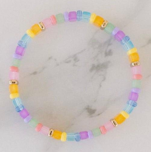 Picture of a brightly colored bracelet with light blue, light pink and yellow beads.
