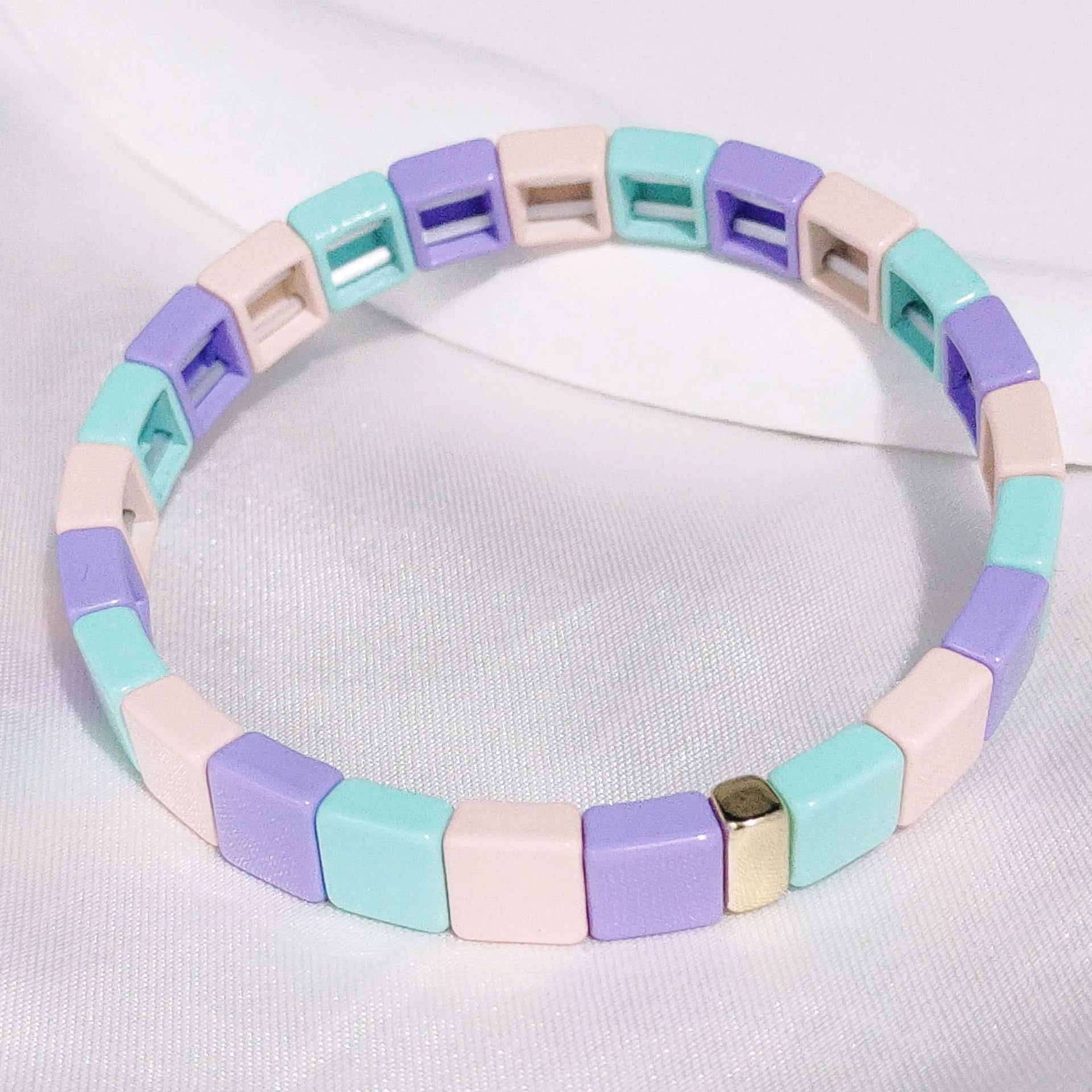 Square bead bracelet in blue, purple and cream.