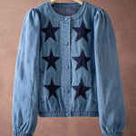 Blue denim jacket with black star patterns on a brown background