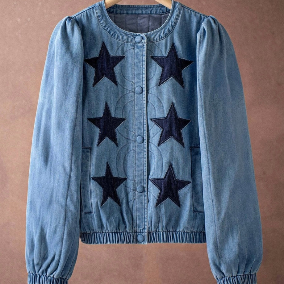 Blue denim jacket with black star patterns on a brown background